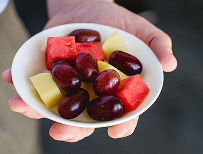 Small bowl of fruit in palm of hand