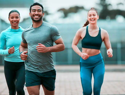 A man and two women jogging