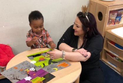 A teacher and young student at a round table