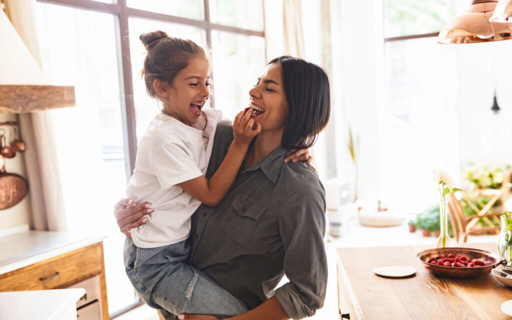 Mother holding daughter on her hip